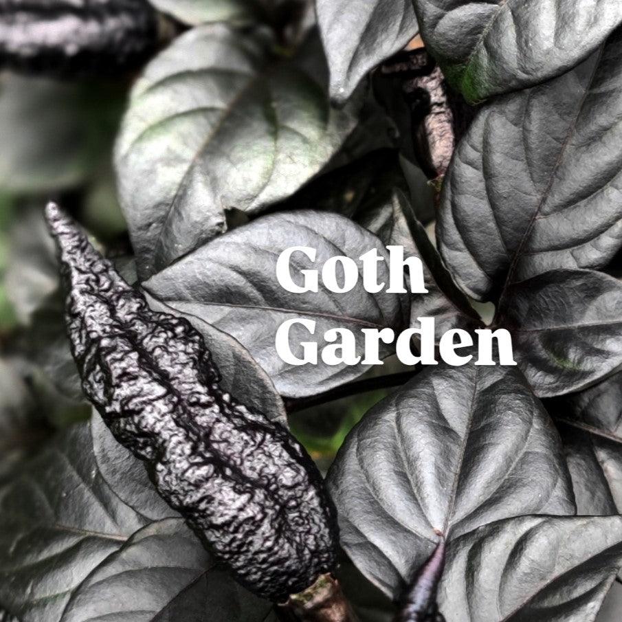 Close-up of dark, almost black plants and leaves with text "Goth Garden" in the center. The plants have a textured, wrinkled appearance, giving a mysterious and gothic theme to the greenery.