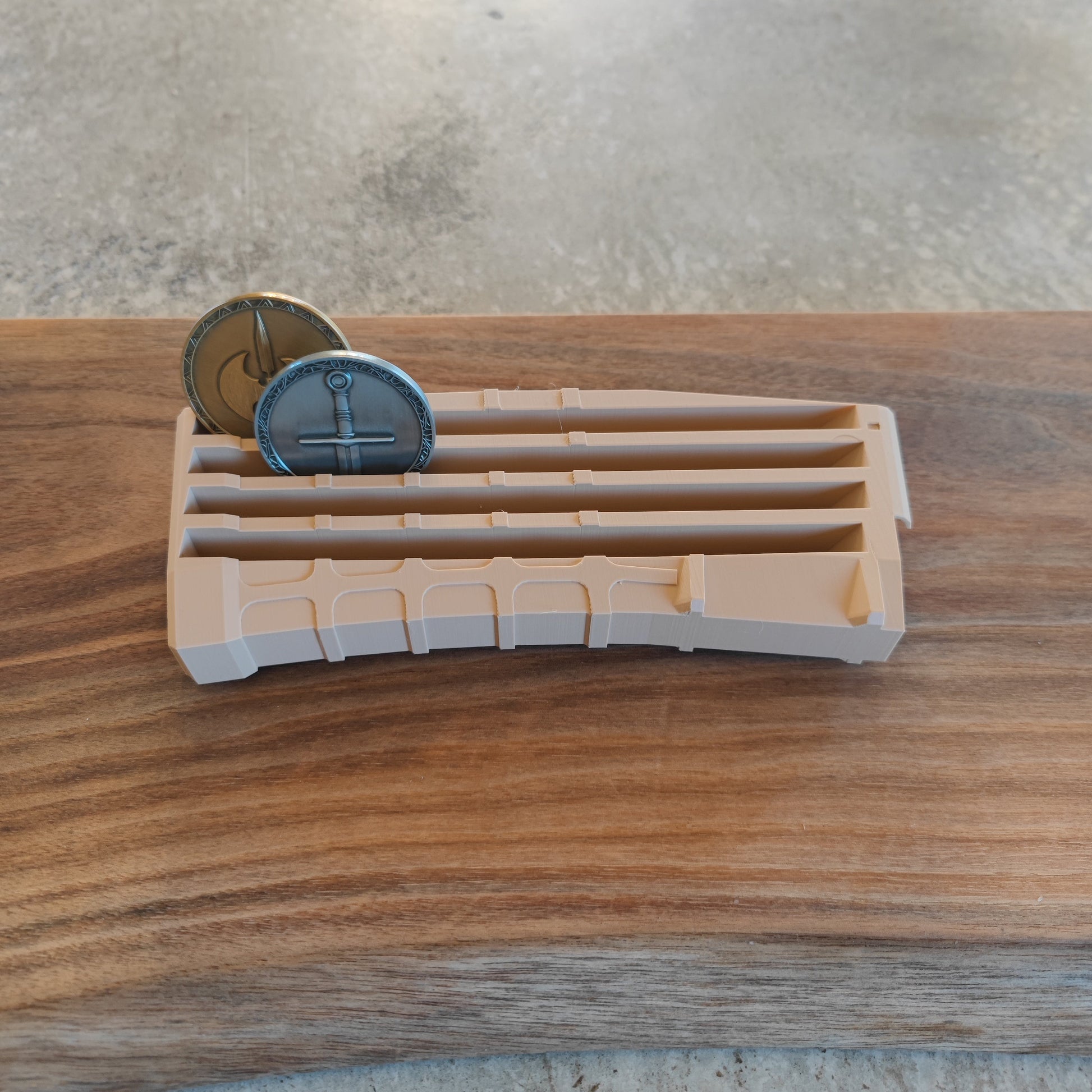 The GEN4 CoinMag - Sand by coin-mag.net is a tan plastic holder with multiple slots, displaying two coins upright on a wooden surface against a textured light background.