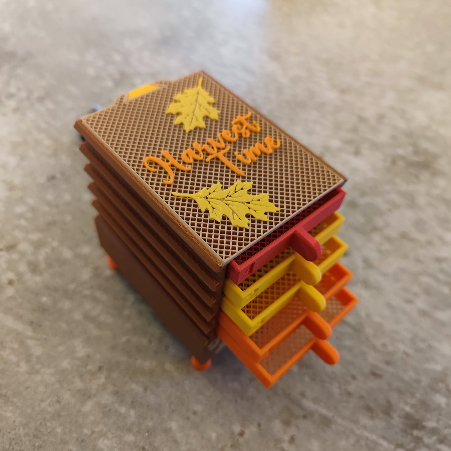 The Seed Dryer - Harvest Time by PepperMerchant.net features five colorful miniature drawers with fall leaf designs and "Harvest Time" on top—ideal for organizing your seed saving supplies or small tools.