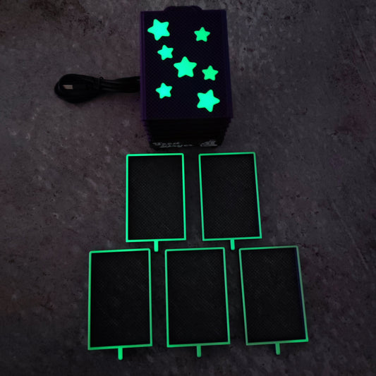 The PepperMerchant.net Seed Dryer - Nightshade (Glows) features a black box with glowing star shapes, a power cord, and five illuminated rectangular elements—showcasing advanced USB-powered seed drying technology.